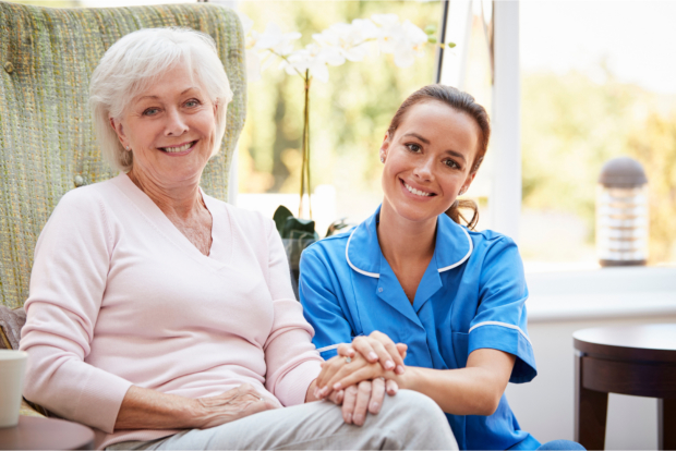 elderly woman with young caregiver smiling